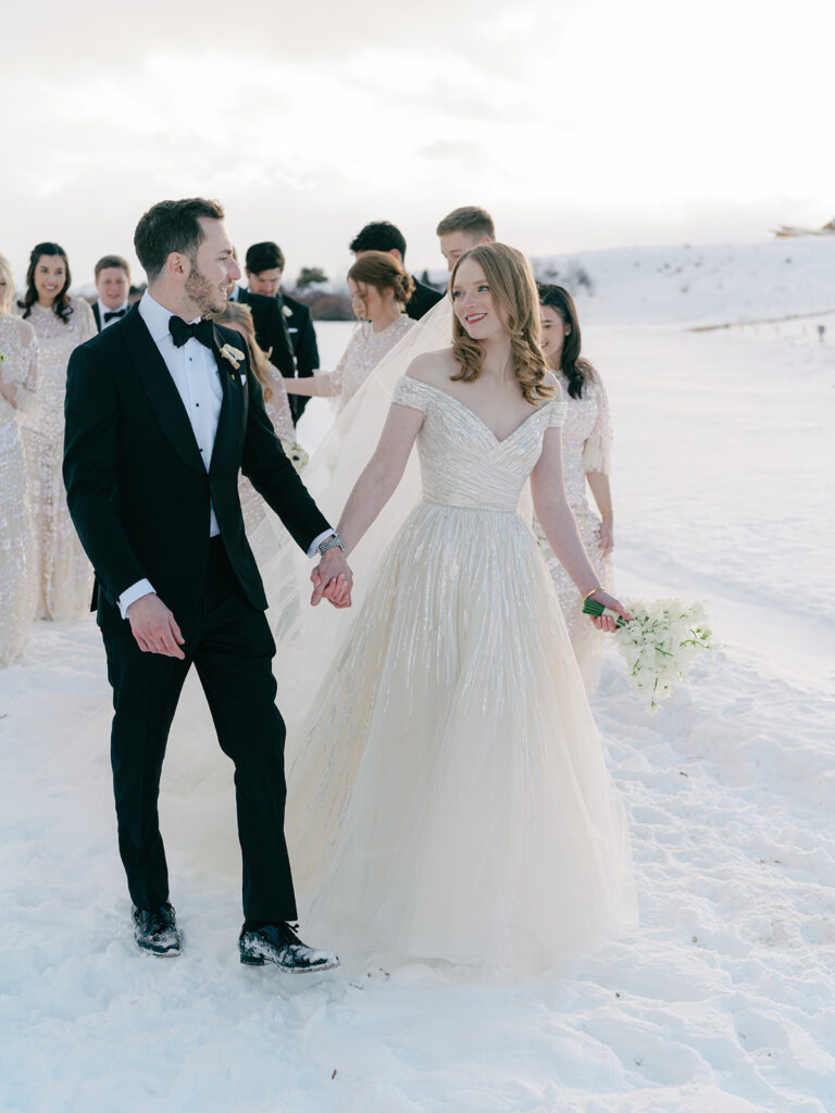 couple with bridal party at their winter wedding at brush creek ranch