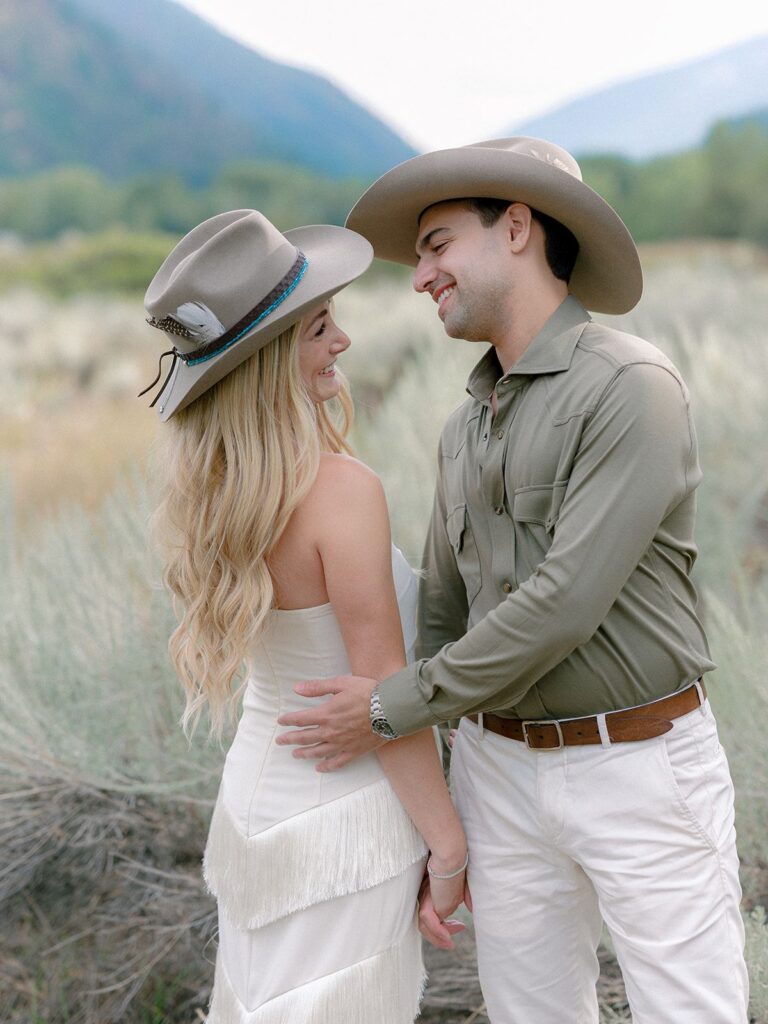 Bride and Groom in cowboy hats at Rehearsal dinner